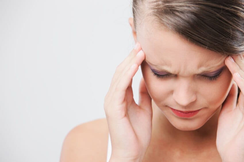 Woman holding her temple due to headache