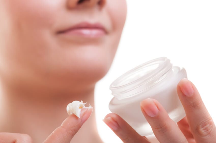 Woman holding skin care cream